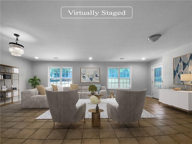 tiled living room featuring a healthy amount of sunlight and a notable chandelier