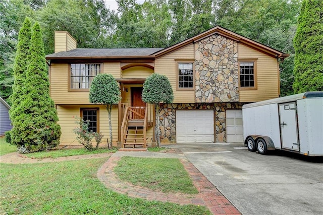 view of front of property featuring a garage and a front lawn