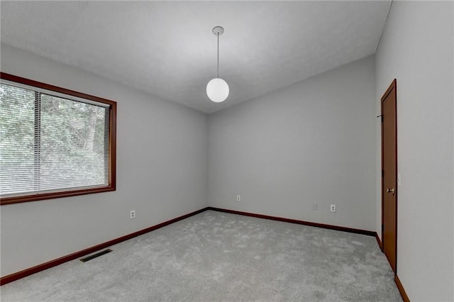 unfurnished room featuring light colored carpet