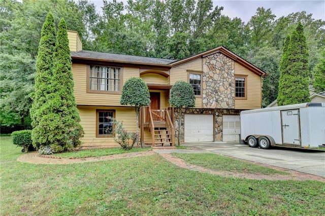 split foyer home with a garage and a front yard