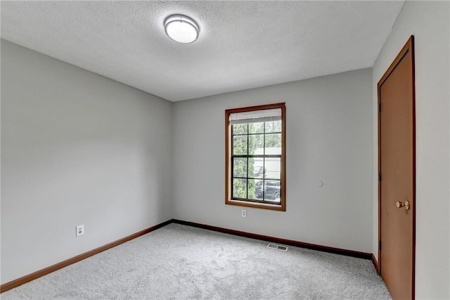 unfurnished bedroom with a textured ceiling and carpet