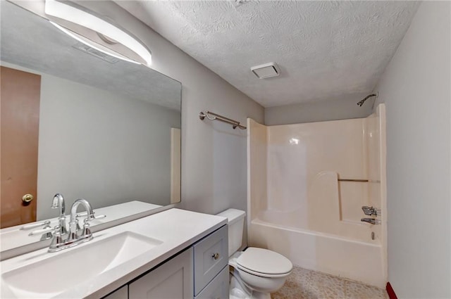 full bathroom with vanity, a textured ceiling, tub / shower combination, and toilet