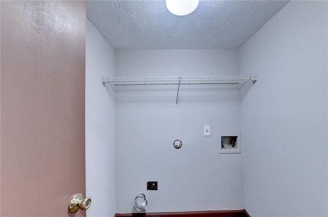 clothes washing area featuring washer hookup, a textured ceiling, and electric dryer hookup