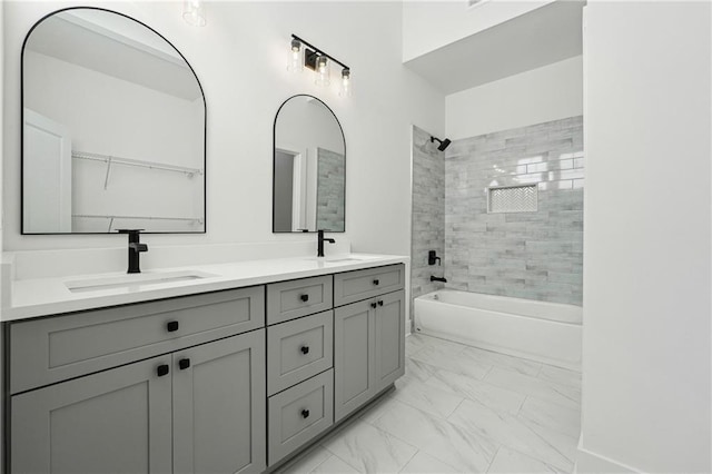 bathroom featuring tiled shower / bath and vanity