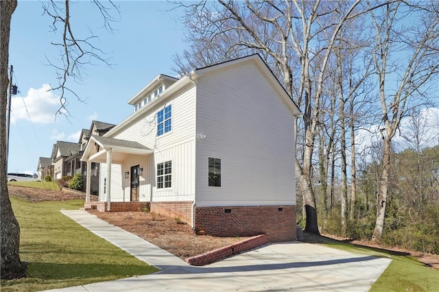 view of side of home with a yard