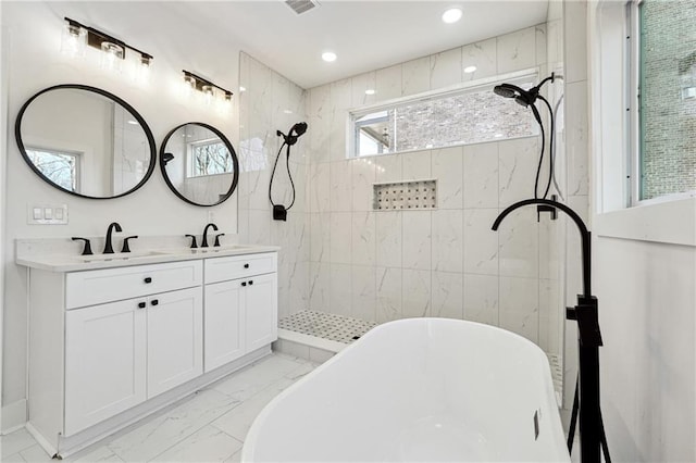 bathroom featuring vanity and separate shower and tub