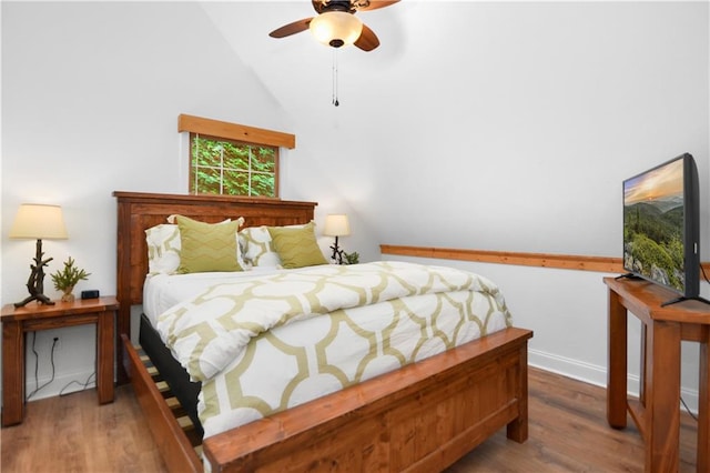 bedroom with ceiling fan, high vaulted ceiling, and wood-type flooring