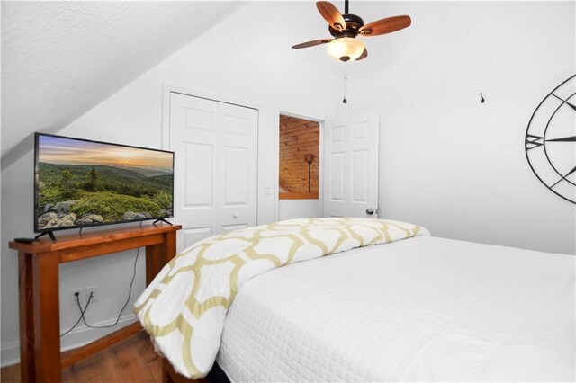 bedroom featuring ceiling fan, hardwood / wood-style flooring, and vaulted ceiling