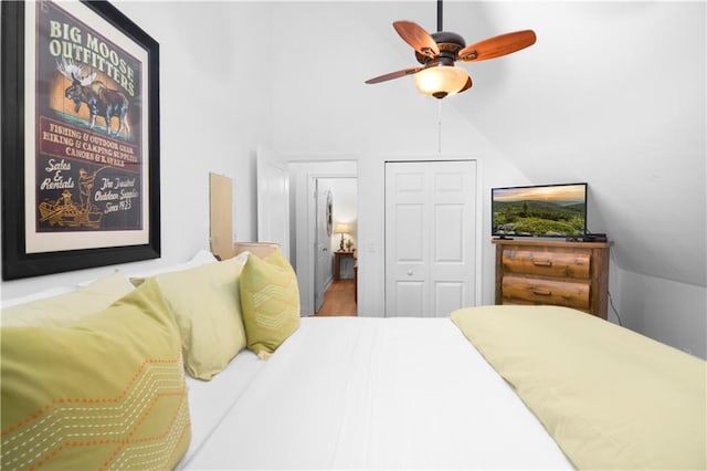 bedroom with ceiling fan, lofted ceiling, and hardwood / wood-style flooring