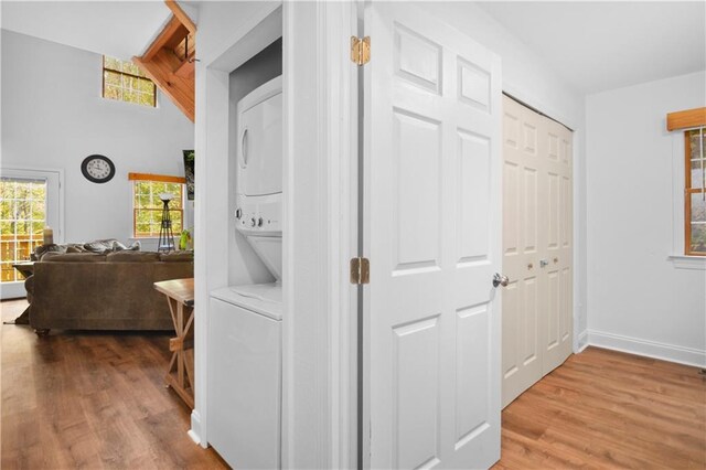 corridor featuring lofted ceiling and light hardwood / wood-style floors