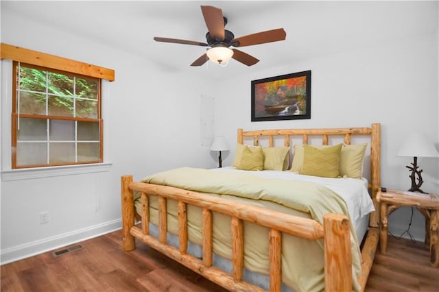 bedroom with ceiling fan and dark hardwood / wood-style flooring