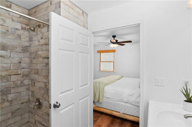 bedroom featuring ceiling fan, sink, and dark hardwood / wood-style flooring