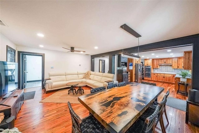 dining room with recessed lighting, light wood-style flooring, and a ceiling fan