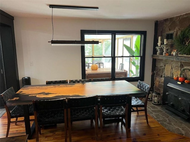 dining room with a fireplace and wood finished floors