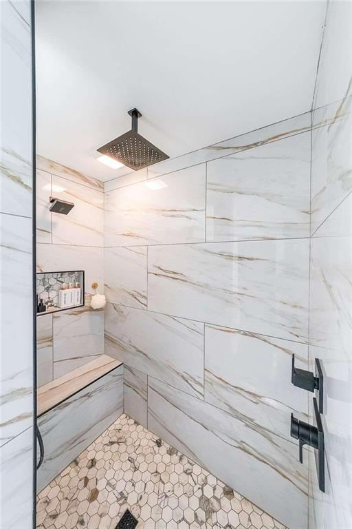 full bath with a tile shower