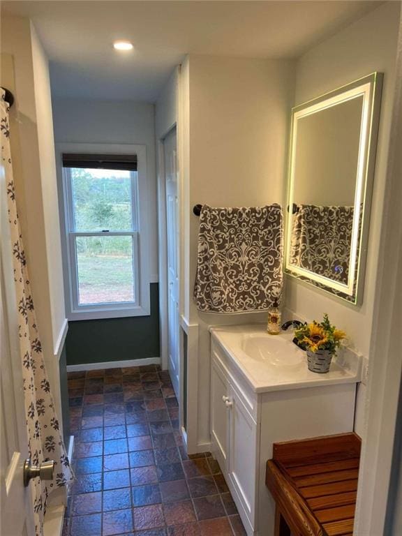 full bath featuring recessed lighting, baseboards, and vanity