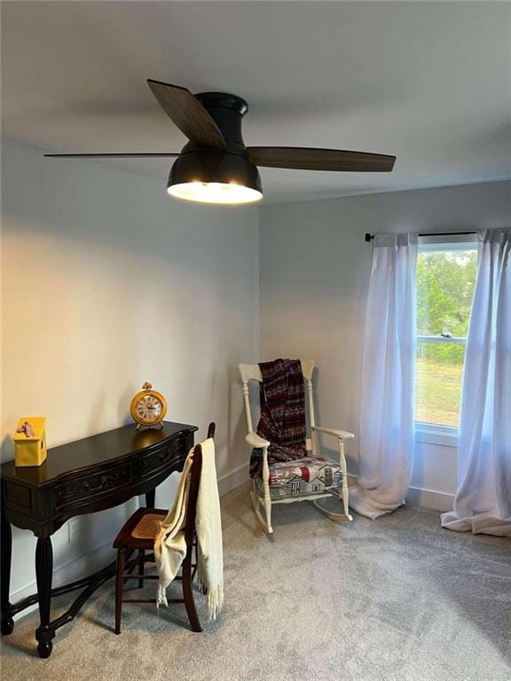 sitting room featuring carpet flooring and baseboards