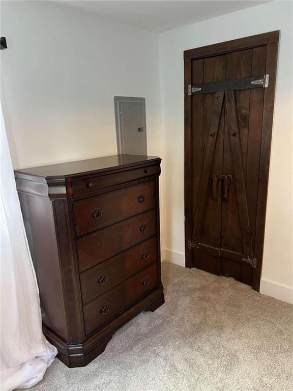 carpeted bedroom featuring electric panel and baseboards