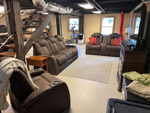 living room with concrete flooring and stairs