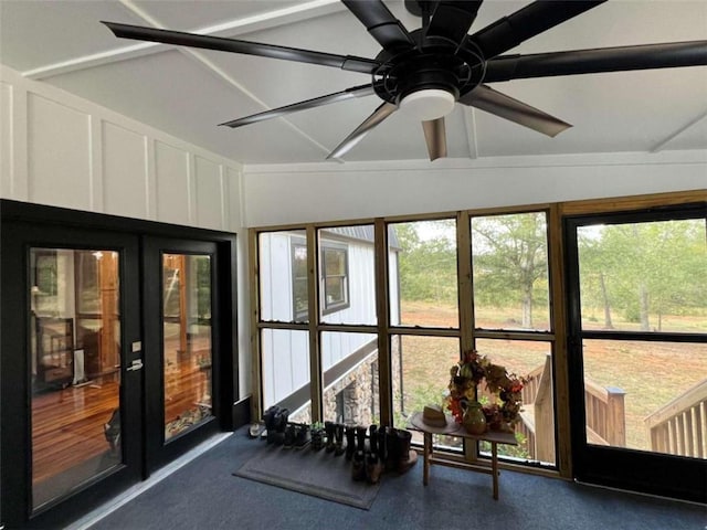 unfurnished sunroom with lofted ceiling and ceiling fan