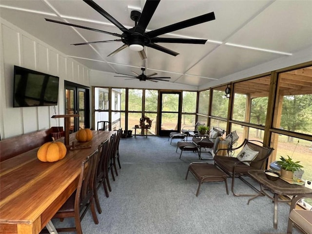 sunroom / solarium featuring lofted ceiling and a ceiling fan