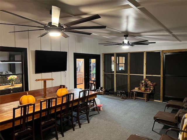 carpeted dining area featuring a ceiling fan and french doors