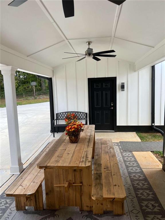 sunroom / solarium with ceiling fan and vaulted ceiling