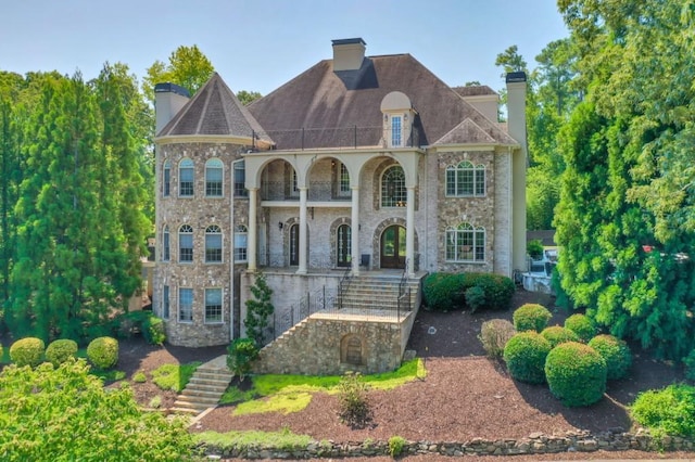 back of property featuring a balcony