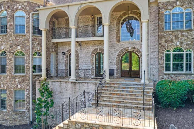 property entrance featuring french doors and a balcony