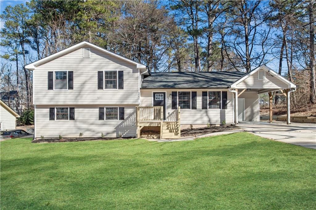 tri-level home with a front yard and a carport