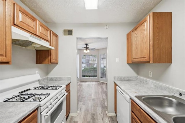 703 Pine Tree Trl, Atlanta, GA 30349 - kitchen featuring white appliances, a textured ceiling, light hardwood / wood-style floors, sink, and ceiling fan