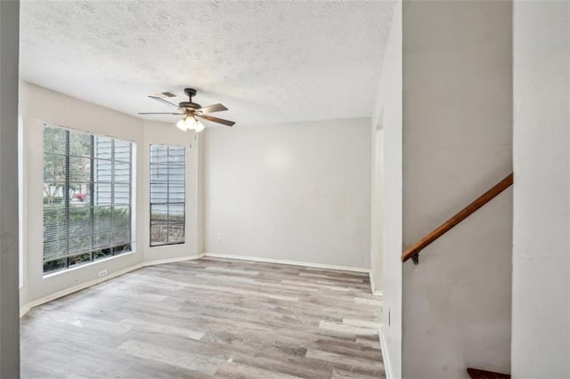 703 Pine Tree Trl, Atlanta, GA 30349 - spare room with a textured ceiling, ceiling fan, and light hardwood / wood-style flooring