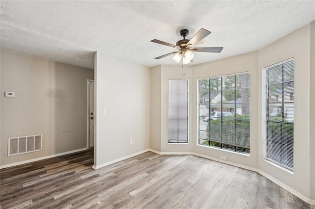 703 Pine Tree Trl, Atlanta, GA 30349 - spare room featuring a textured ceiling, ceiling fan, and wood-type flooring
