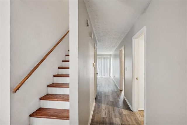 703 Pine Tree Trl, Atlanta, GA 30349 - staircase featuring wood-type flooring and a textured ceiling