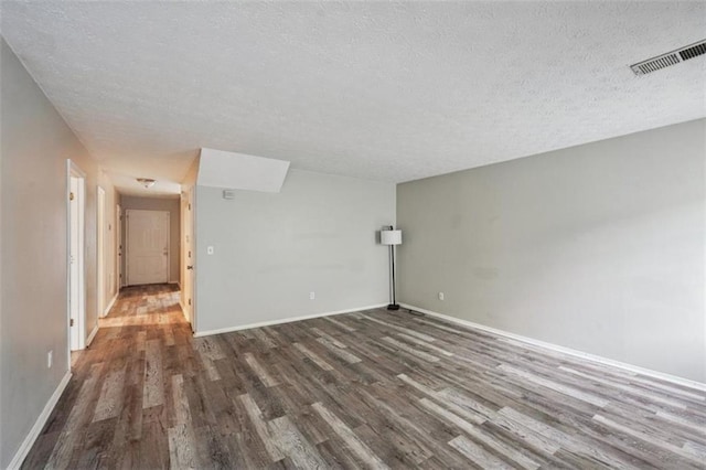 703 Pine Tree Trl, Atlanta, GA 30349 - spare room with dark wood-type flooring and a textured ceiling