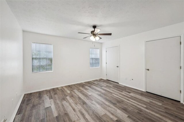 703 Pine Tree Trl, Atlanta, GA 30349 - spare room with ceiling fan, a healthy amount of sunlight, a textured ceiling, and hardwood / wood-style floors