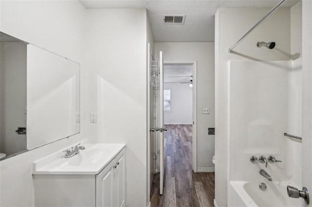 703 Pine Tree Trl, Atlanta, GA 30349 - full bathroom with a textured ceiling, shower / bathing tub combination, vanity, and toilet