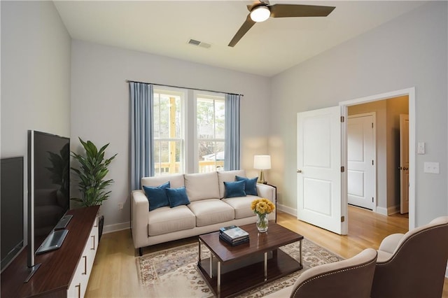 living room featuring ceiling fan and light wood-type flooring