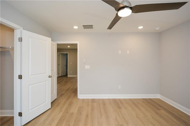 empty room with ceiling fan and light hardwood / wood-style flooring