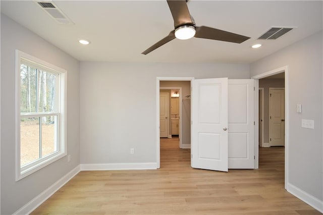 unfurnished bedroom with ceiling fan and light hardwood / wood-style floors