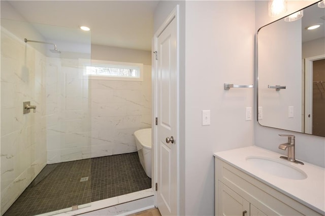 bathroom with vanity and a tile shower