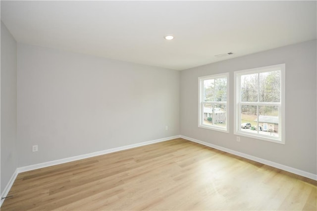 spare room with light hardwood / wood-style floors