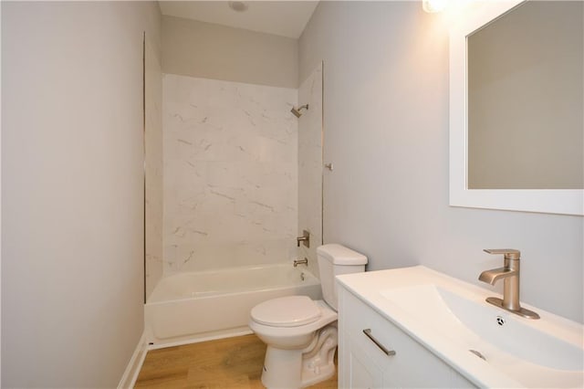 full bathroom featuring vanity, hardwood / wood-style floors, toilet, and tiled shower / bath