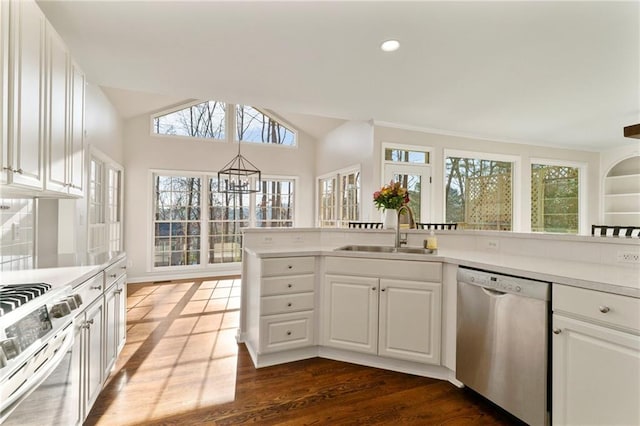 kitchen featuring range with gas cooktop, a sink, vaulted ceiling, light countertops, and stainless steel dishwasher