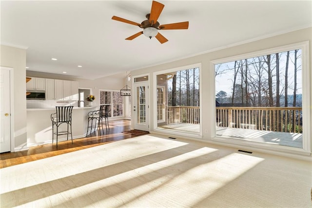 interior space with plenty of natural light, visible vents, and ceiling fan