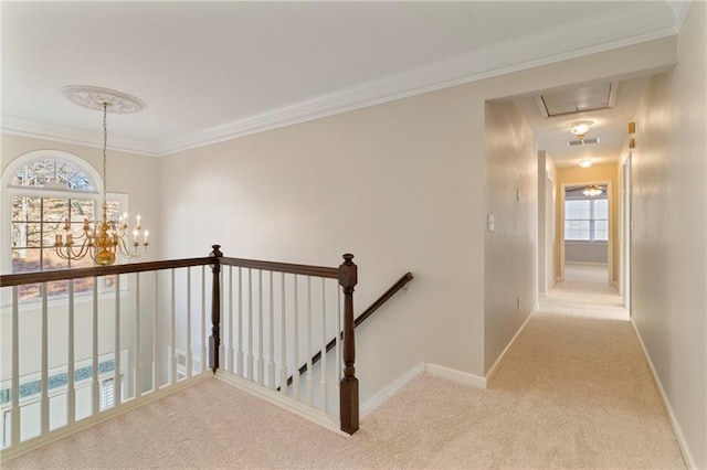 corridor with visible vents, carpet, baseboards, attic access, and an upstairs landing