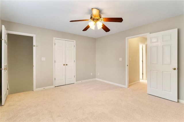 unfurnished bedroom featuring light colored carpet, baseboards, a closet, and ceiling fan