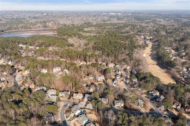 drone / aerial view with a view of trees and a water view