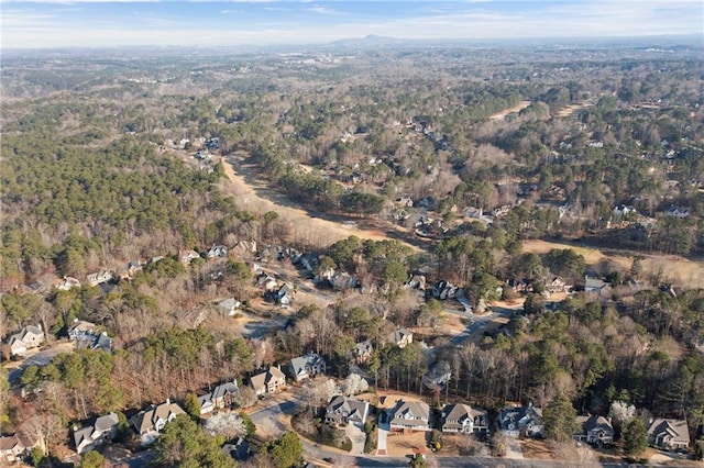 drone / aerial view featuring a forest view