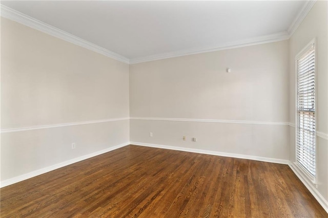 unfurnished room with crown molding, dark wood-type flooring, and baseboards